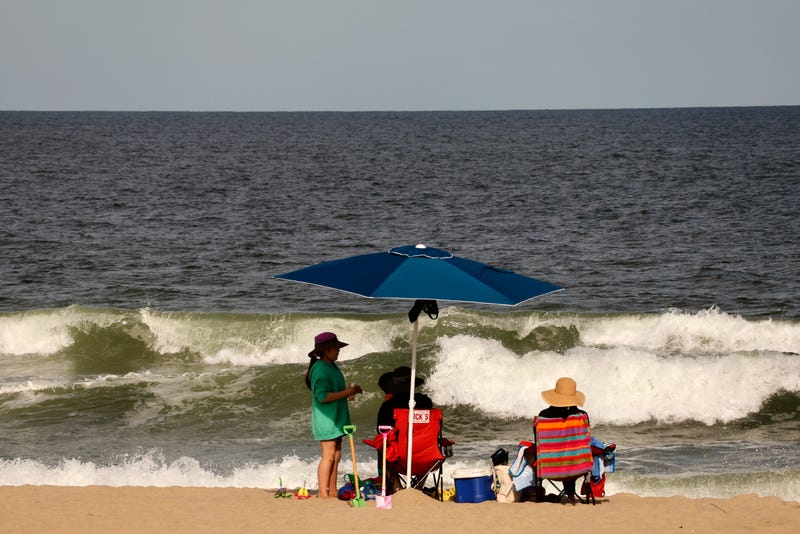People sit on the beach in Asbury Park on Memorial Day weekend on May 28, 2023, in Asbury Park, New Jersey. (Photo by