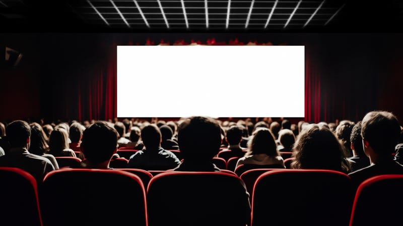 Packed movie theater watching a film.
