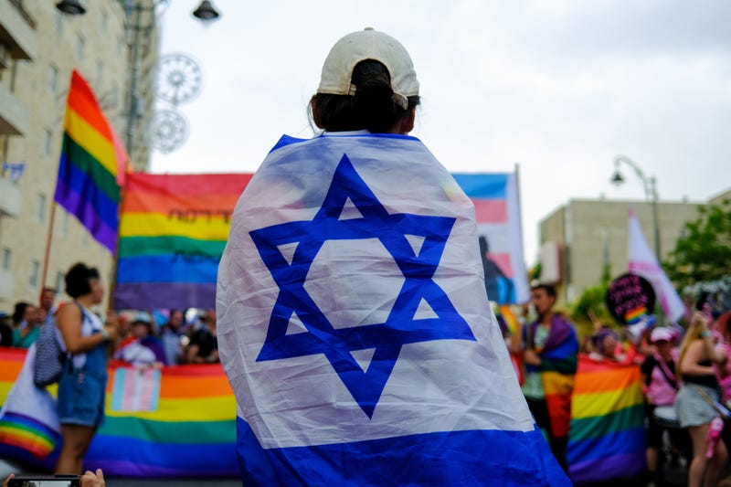 A person draped in an Israeli flag participates in the 21st annual LGBTQ Jerusalem March for Pride and Tolerance on June 01, 2023 in Jerusalem, Israel.