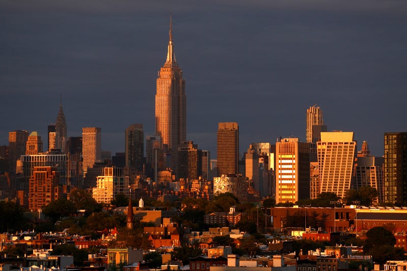 The sun sets on the skyline of midtown Manhattan on June 4, 2023