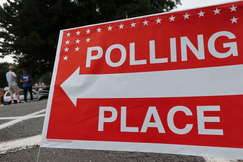 A sign showing a polling station for voters