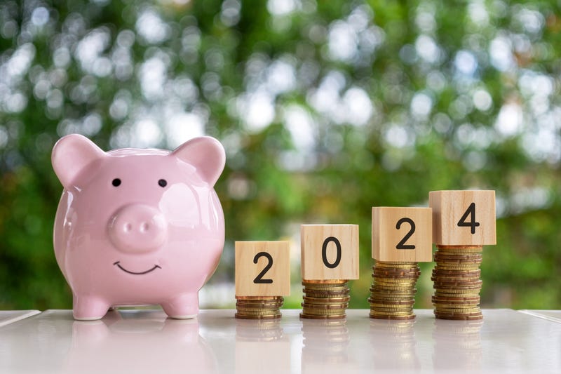 Piggy bank next to increasing stacks of coins