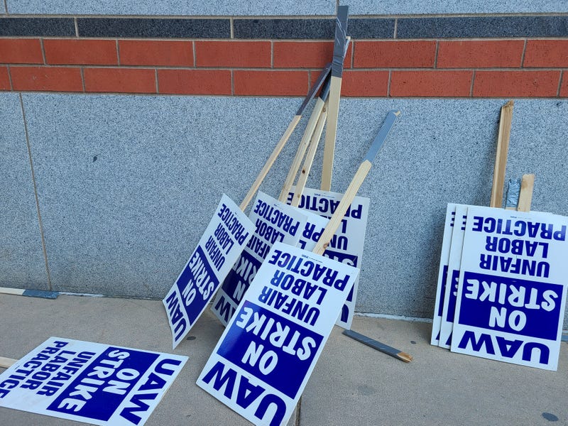 Strike signs resting on the wall.