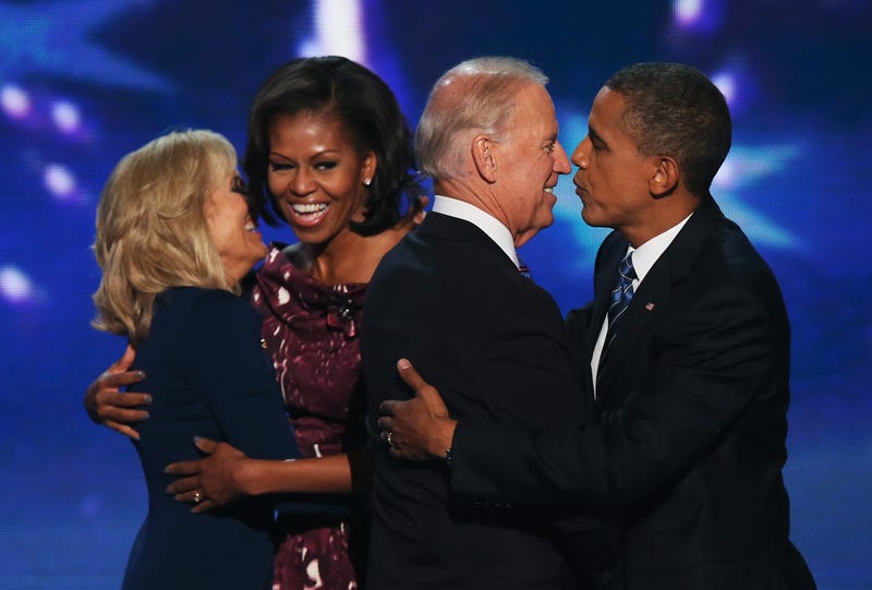 Dr. Jill Biden hugs Michelle Obama, as Joe Biden greets Barack Obama on stage after accepting the nomination during the final day of the Democratic National Convention at Time Warner Cable Arena on September 6, 2012 in Charlotte, North Carolina.