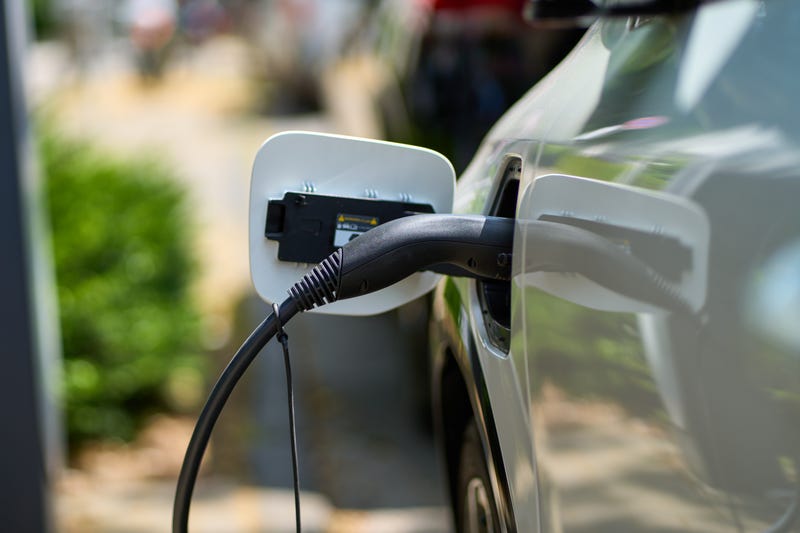 An electric vehicles is getting charged.