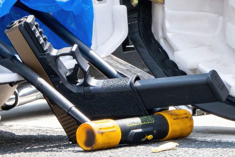 A firearm is seen on a street in Jamaica on Saturday following the shooting rampage