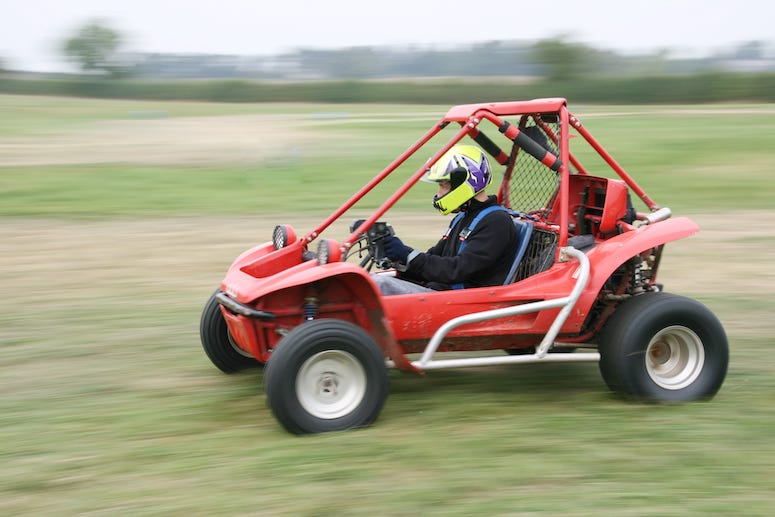 Man riding go-kart in field