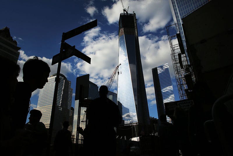 Pedestrians walk by the Freedom Tower on the eve of the 11th anniversary of September 11 terrorist attacks on September 10, 2012 in New York City. New York City and the nation are preparing to commemorate the event which lead to two wars and the deaths of thousands. On Monday the federal government announced that they will add as many as 50 different types of cancers to health issues to be covered by the Zadroga 9/11 Health and Compensation Act for first responders. (Photo by Spencer Platt/Getty Images
