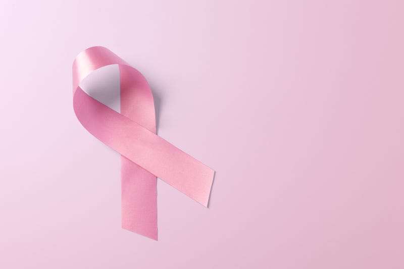 Breast cancer awareness ribbon on light pink background