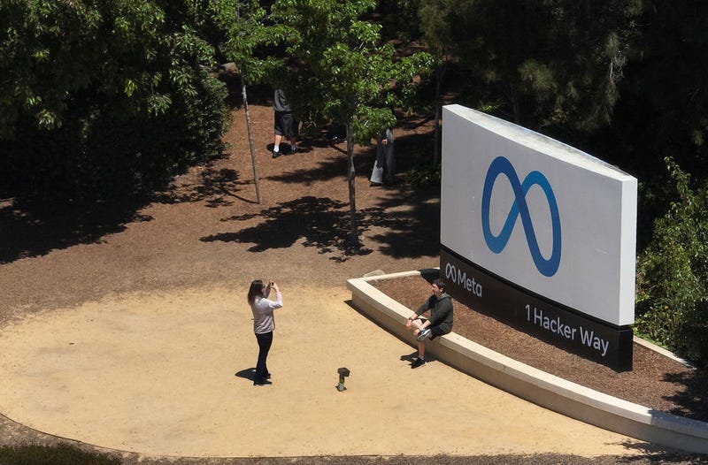 In an aerial view, people gather in front of a sign posted at Meta headquarters on July 07, 2023 in Menlo Park, California.