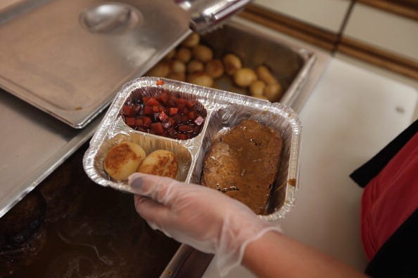 A nutrition specialist prepares a "Meals on Wheels" delivery