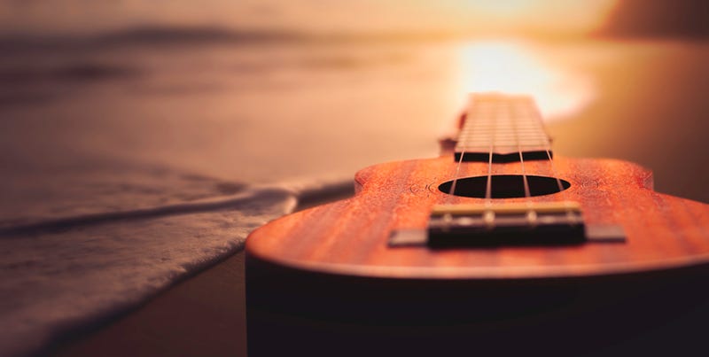 acoustic guitar on beach at sunset