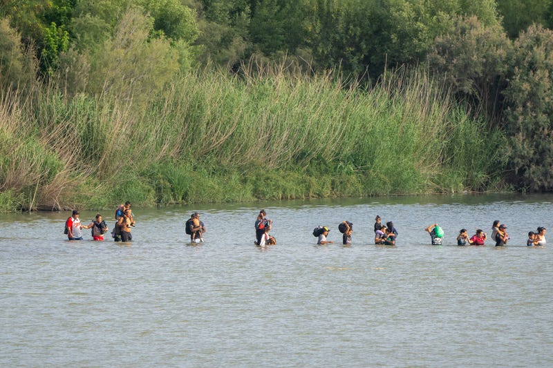 Migrants cross the Rio Grande from the Mexican side of the border towards the U.S. on July 16, 2023, as seen from Eagle Pass, Texas