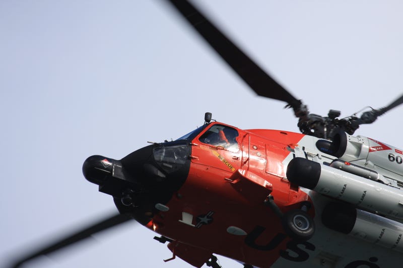 A closeup of a U.S. Goast Guard HH-60 Jayhawk that flies overhead