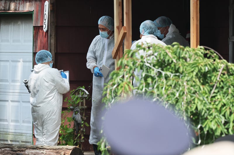 Law enforcement officials are seen as they investigate the home of a suspect arrested in the unsolved Gilgo Beach killings on July 14, 2023 in Massapequa Park