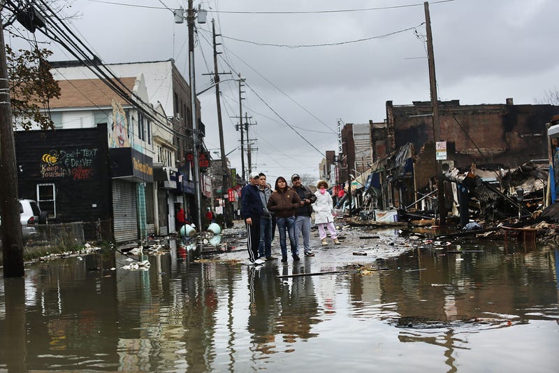 People look at homes and businesses destroyed during Sandy on Oct. 30, 2012 in Rockaway, Queens