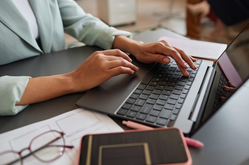 Woman typing on computer keyboard