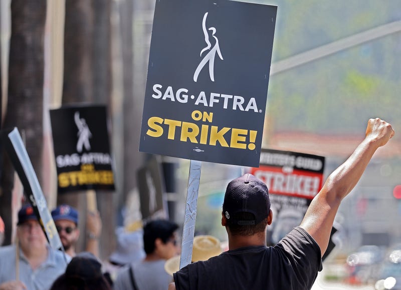 Striking SAG-AFTRA members picket with striking WGA (Writers Guild of America) workers outside Warner Bros. Studio on July 17, 2023 in Burbank, California.