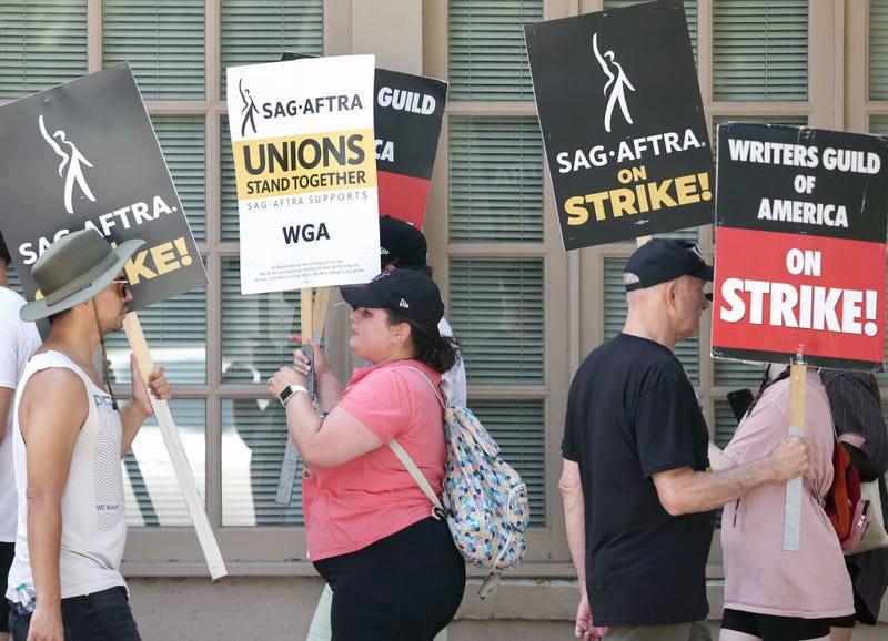 Striking SAG-AFTRA members picket with striking WGA (Writers Guild of America) workers on Day 5 outside Warner Bros. Studio on July 17, 2023 in Burbank, California.
