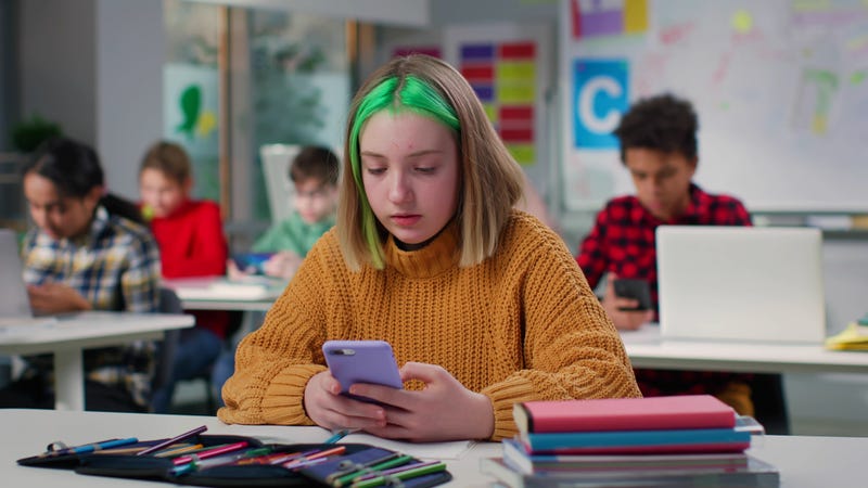 Student with phone in classroom