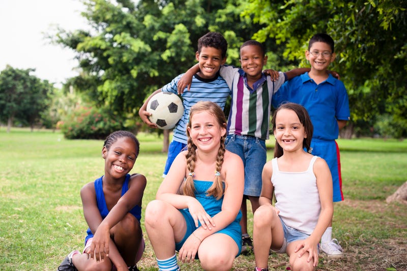 Kids playing soccer at a summer camp