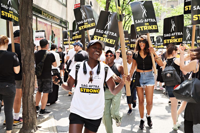 lupita nyong'o and other striking actors with picket signs