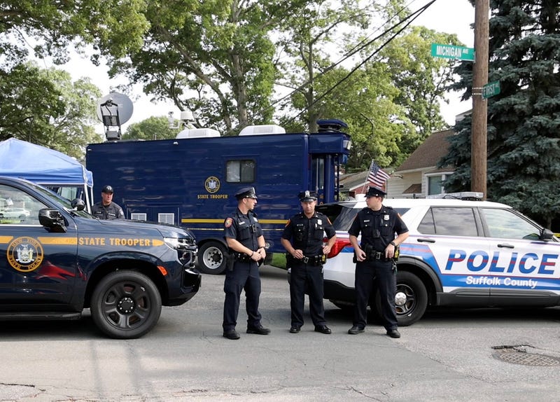 Police and crime scene investigators are seen outside the Massapequa Park home of Gilgo Beach murder suspect Rex Heuermann on July 20, 2023