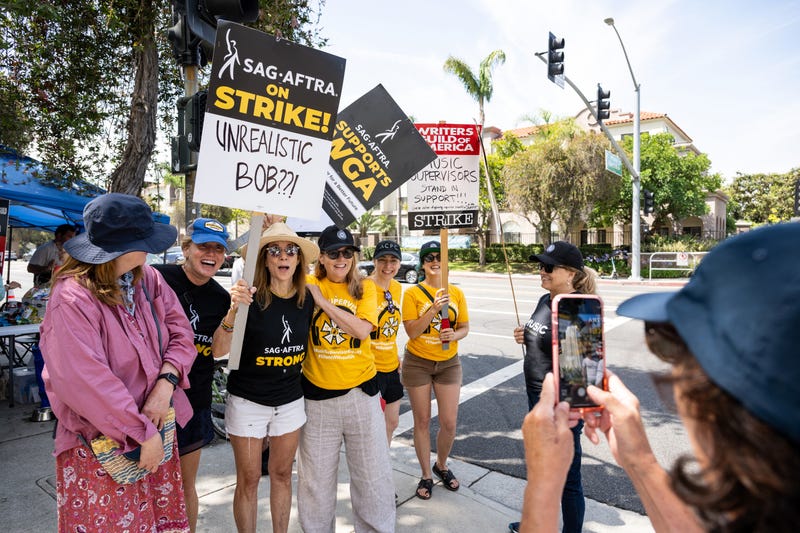 picketer with a sing that says 'unrealistic bob?'