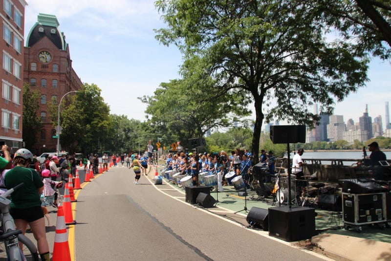 A music group plays on a temporarily car-free street in the New York borough of Queens on July 29, 2023.