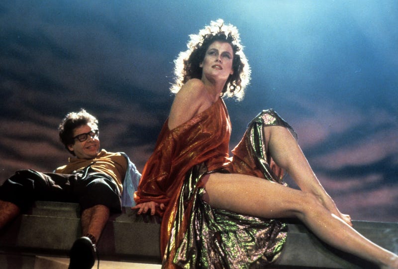 A smiling Rick Moranis looks up at Sigourney Weaver in a scene from the 1984 film "Ghostbusters"