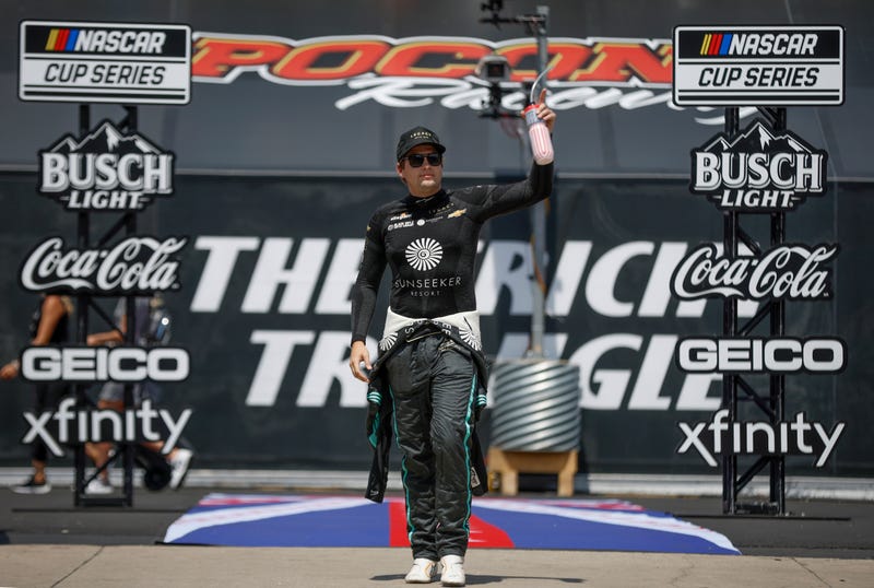 Noah Gragson, driver of the #42 Sunseeker Resort Chevrolet, waves to fans as he walks out during driver intros prior to the NASCAR Cup Series HighPoint.com 400 at Pocono Raceway on July 23, 2023.