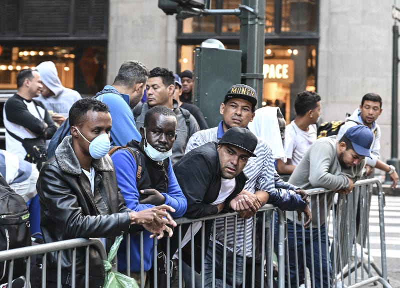 Migrants line up outside Roosevelt Hotel in Manhattan this month