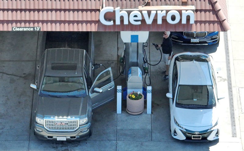 In an aerial view, a customer prepares to pump gas into his car at a Chevron gas station on July 26, 2023 in Mill Valley, California.
