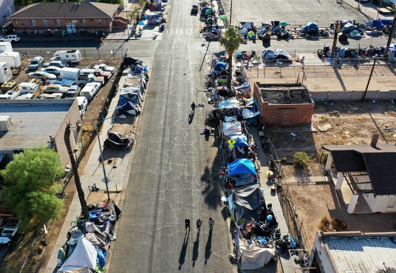 In an aerial view, people walk through a section of the 'The Zone', Phoenix's largest homeless encampment, amid the city's worst heat wave on record on July 26, 2023 in Phoenix, Arizona.