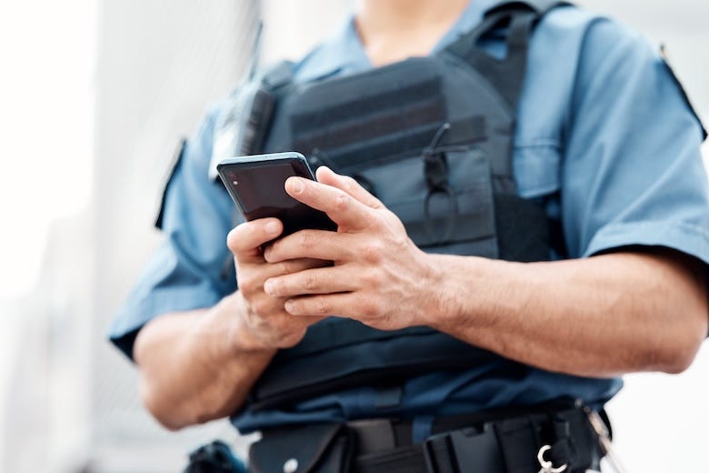 Police officer holding smartphone