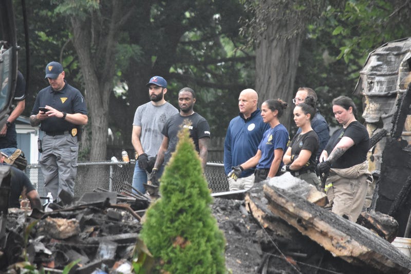 Police, firefighters and search and rescue teams continue to work after a house exploded in Buena, New Jersey, on Aug. 4, 2023