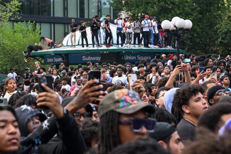 People gather for a "giveaway" event in Union Square and the surrounding area on Aug. 4, 2023