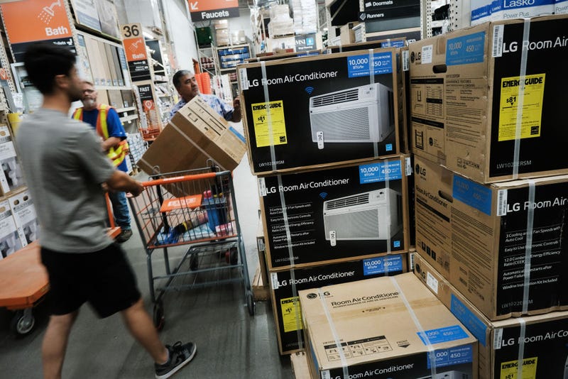 Men purchase an air conditioner at a Home Depot during a heat wave in Brooklyn on July 28, 2023 in New York City. New York City and much of the East Coast are experiencing their first real heat wave of the summer season with temperatures in the high 90's and a heat index of over 100 degrees.
