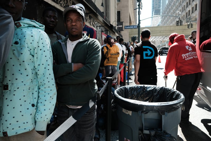 Hundreds of recently arrived migrants to New York City wait outside of the Roosevelt Hotel last week