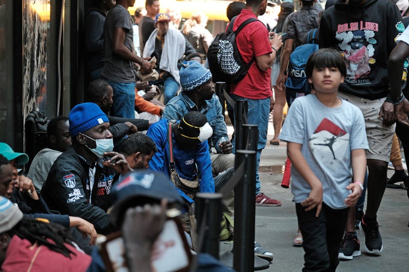Hundreds of recently arrived migrants to New York City wait outside of the Roosevelt Hotel on July 31, 2023
