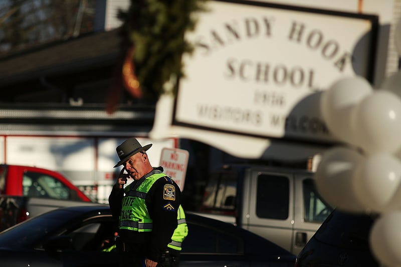 A police officer stands outside of the entrance to the Sandy Hook Elementary School on Dec. 15, 2012, in Newtown, Connecticut.