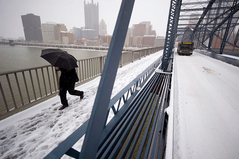 A pedestrian crosses the Smithfiled Street Bridge after a winter storm