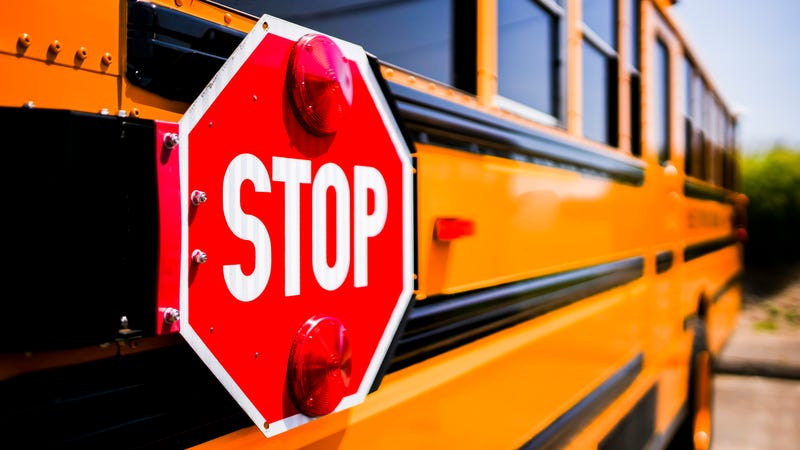 Closeup of a school bus' stop sign.