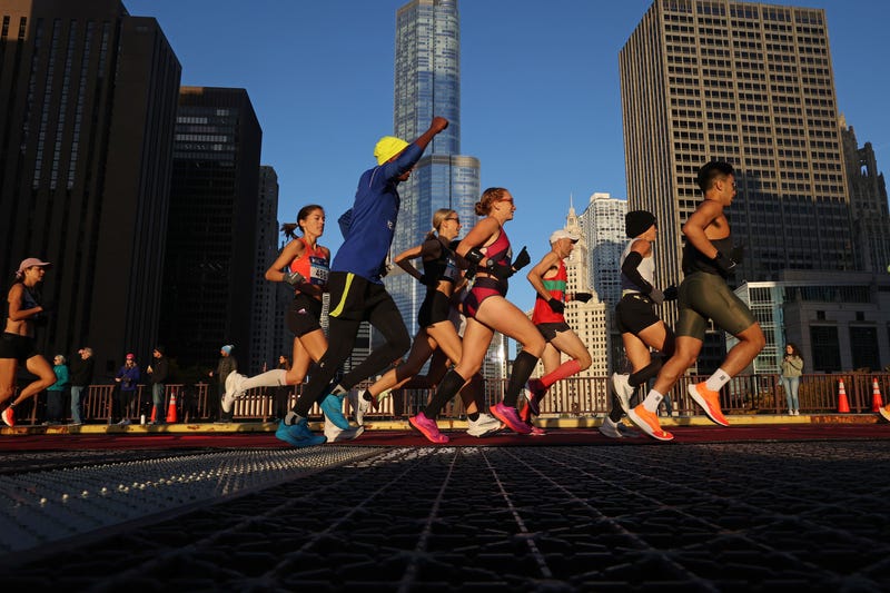 Marathon runners head down Columbus Drive in the early sunlight as the Bank of America Chicago Marathon starts on Oct. 9, 2022.
