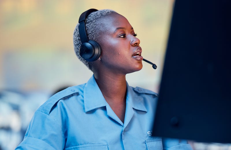 Woman taking emergency phone call at desk