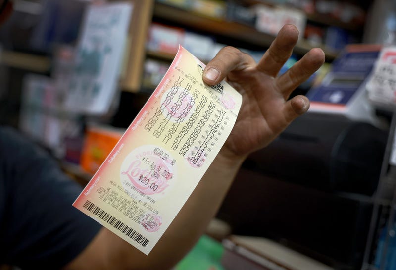A hopeful lottery ticket holder shows off his Mega Millions lottery ticket that he bought at Bob's News & Books store on August 04, 2023 in Fort Lauderdale, Florida. 