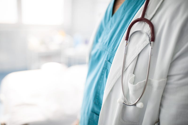Close up photo of stethoscope around the neck of unrecognizable doctor