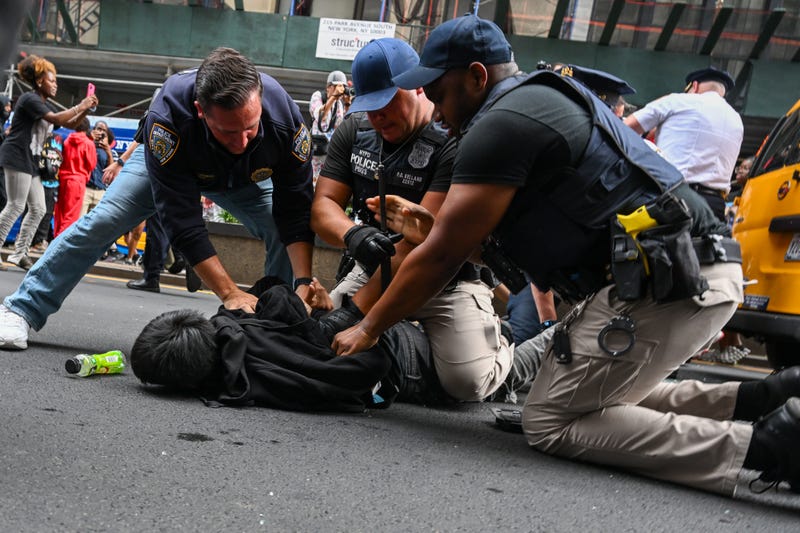 Members of the NYPD arrest people after responding to thousands of people gathered for a "giveaway" event in Union Square and the surrounding area on Aug. 4, 2023