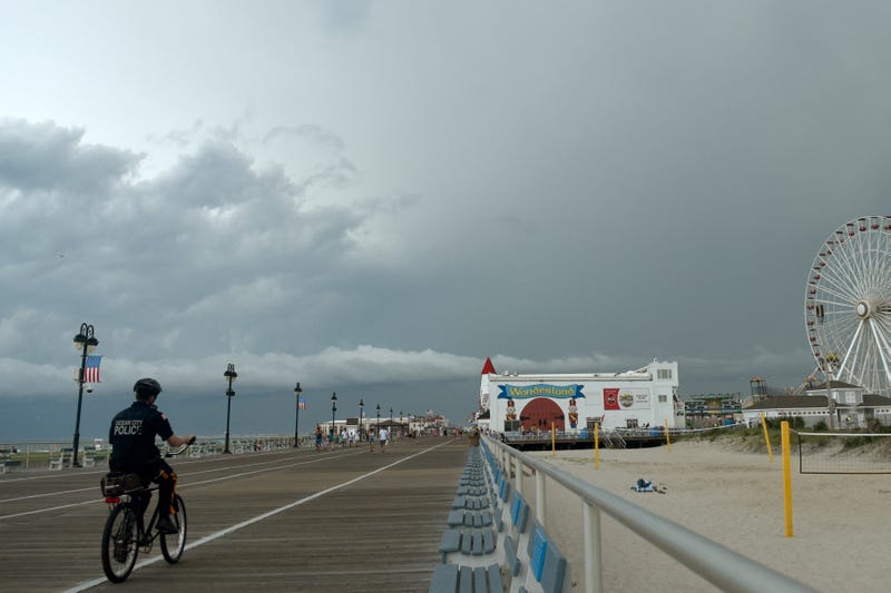 An Ocean City police officer patrols on a bike on the boardwalk, July 25, 2023.