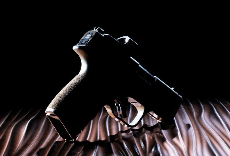 Dark semi-automatic handgun chambered in 9 mm with no discernible features much like a ghost gun
